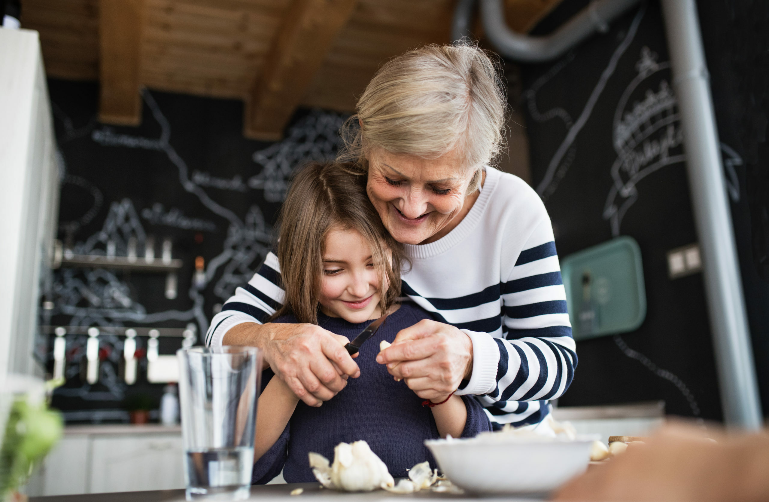 Grandparent cooking with grandchild