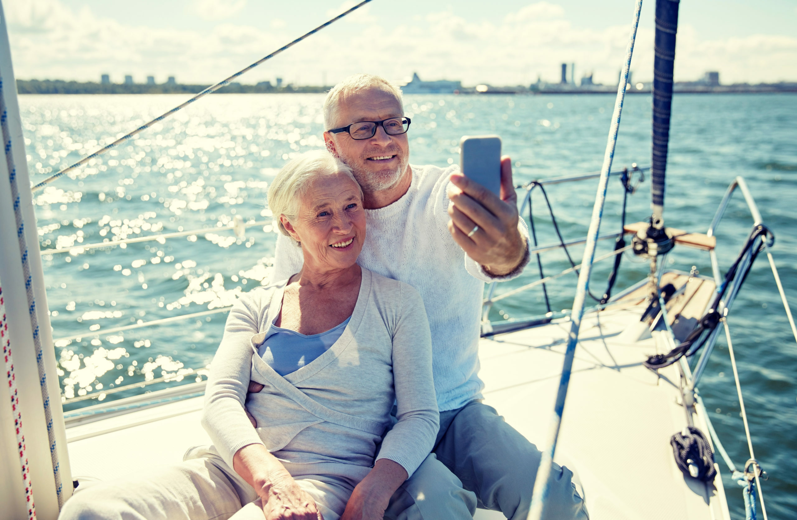 Retired couple taking a photo on boat