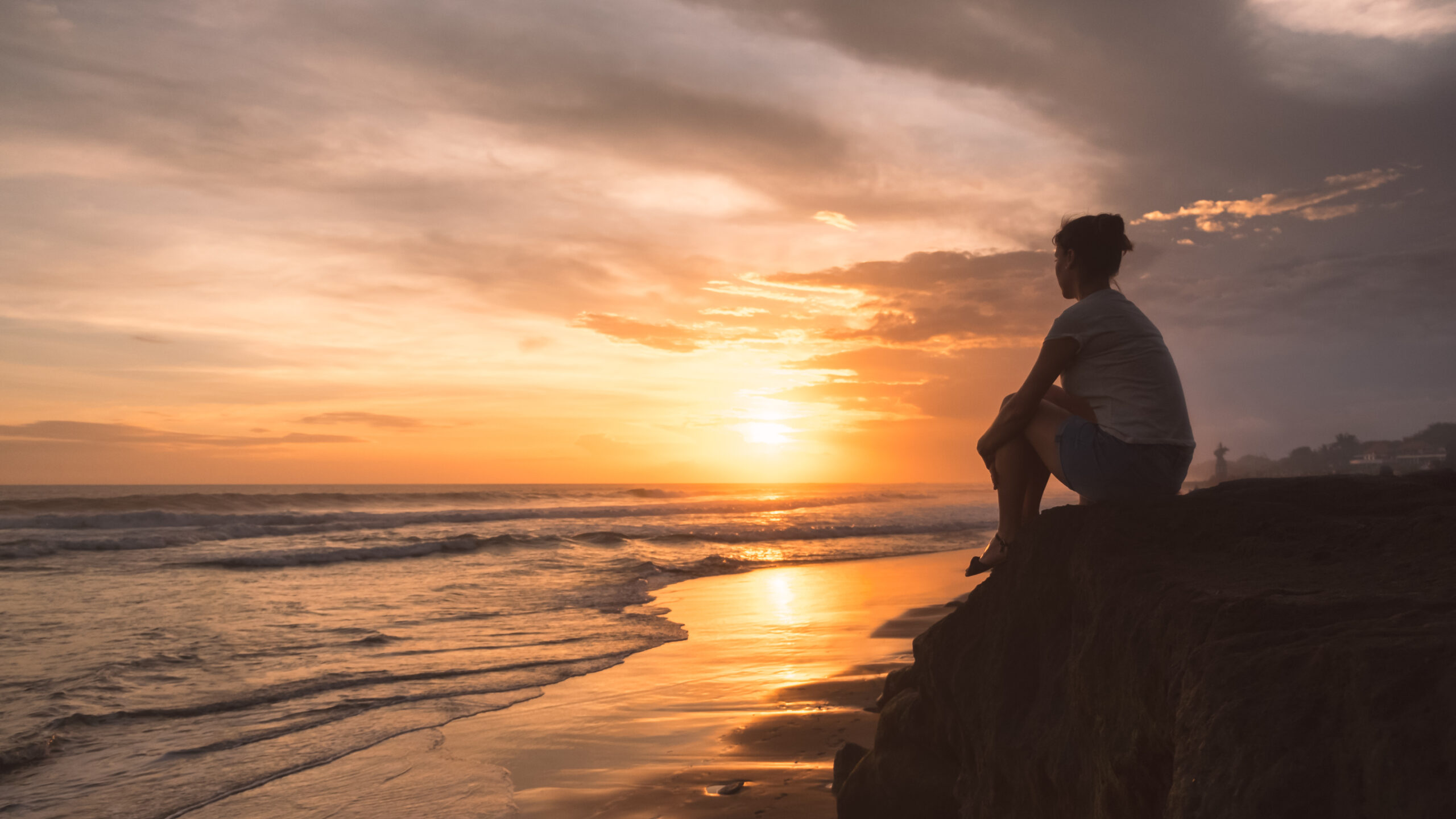 woman sitting watching the sunset