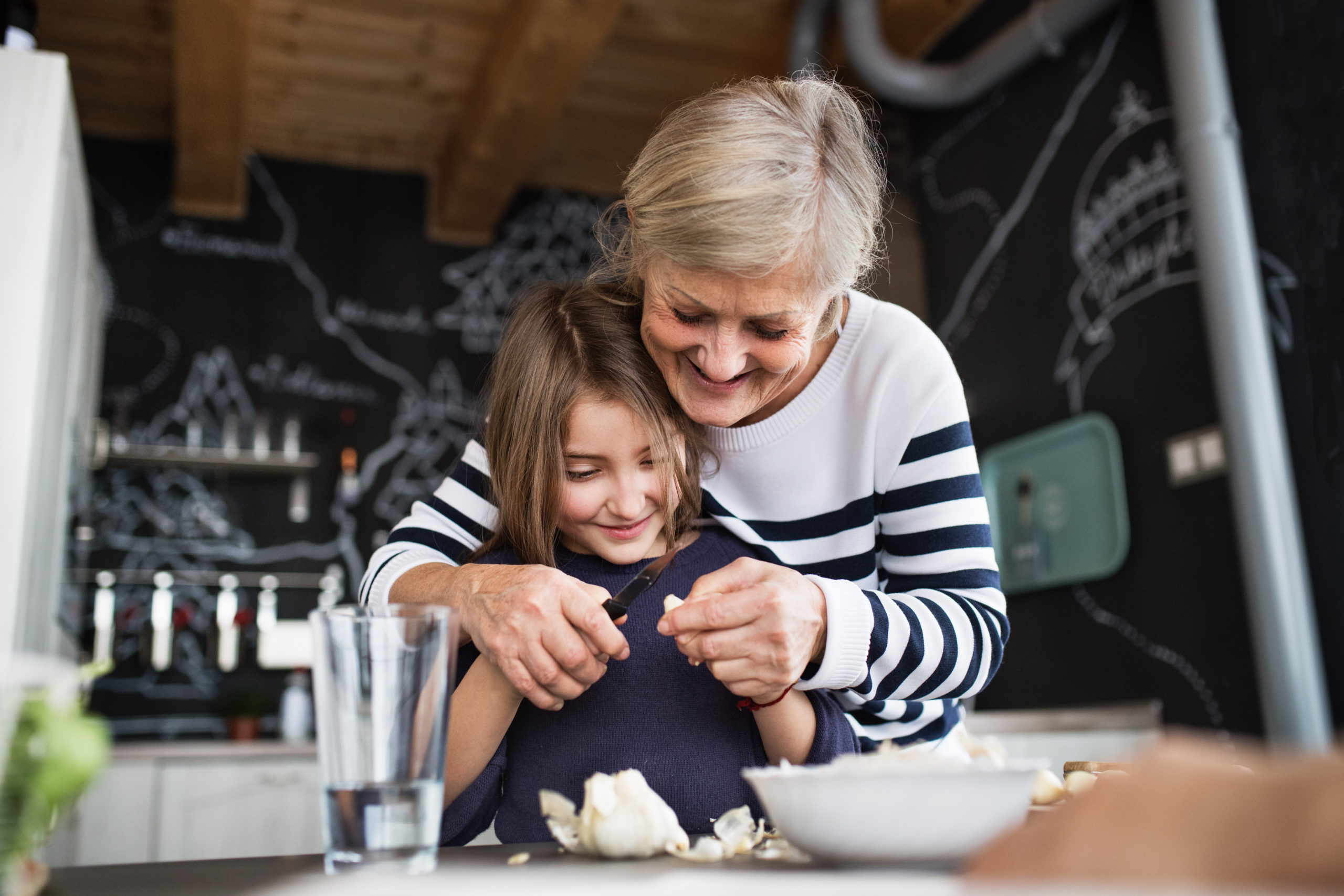 grandmother cooking with granddaughter