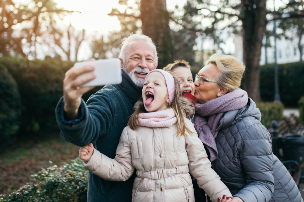 Grandparents taking selfie with grandchildren