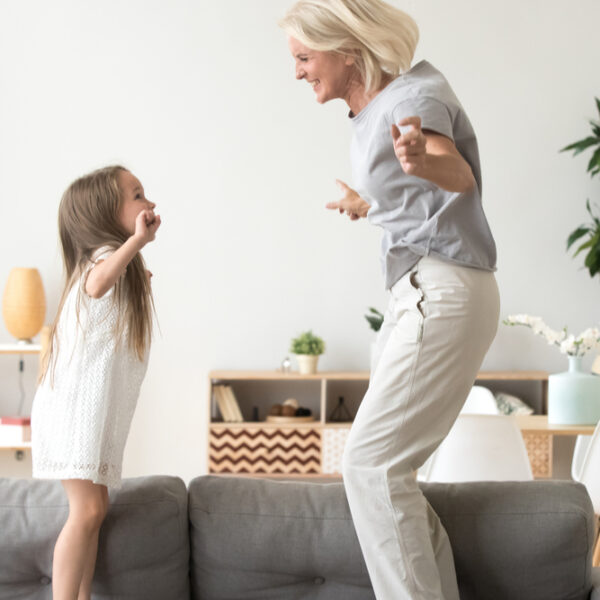 girl playing with older woman in home